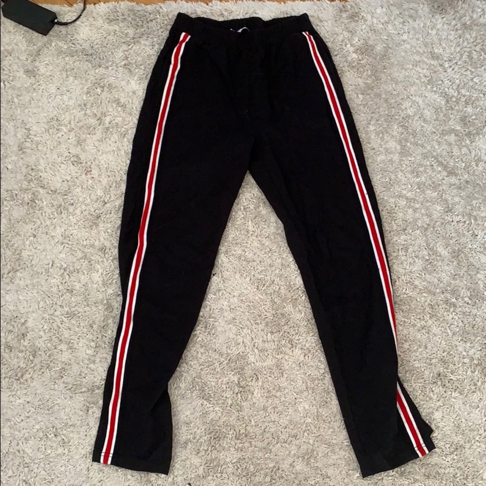 Long black pants with red and white stripe